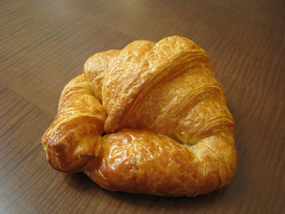 An intact croissant on a table