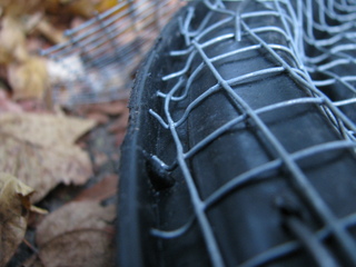 Closeup photo of rim, with cut ends of mesh bent down into
a small but broad groove.