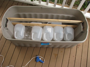 The tub is upright again and has assorted plastic jugs and bottles lying on their sides in the bottom.